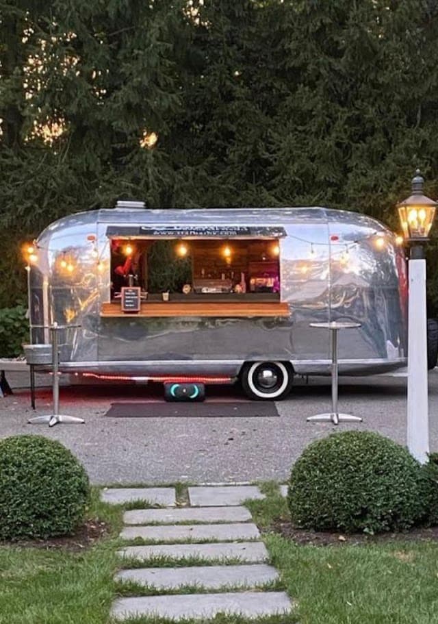 STARBAR NY Airstream trailer bar with a stone path at an estate event
